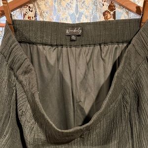 Rayon/Polyester gauze completely lined with pockets.  Sage green